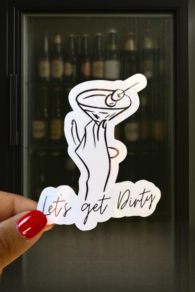 Minimalist line drawing of a hand holding a martini glass with an olive, paired with the phrase “Let’s get Dirty.”